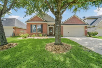 Charming front yard highlighted by mature trees and manicured lawn