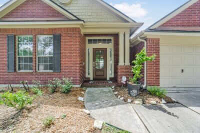 nviting covered front entry with elegant brick