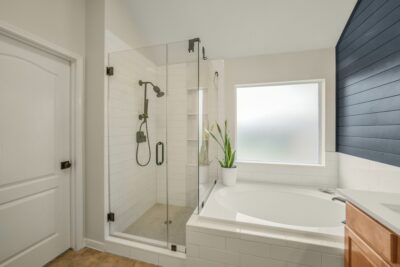 Primary bathroom showcasing oversized shower, soaking tub, and dual sinks.