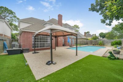 Backyard oasis with pool and greenspace