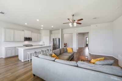 Open-concept living room with elevated ceilings and oversized windows at 2952 Golden Dust Drive