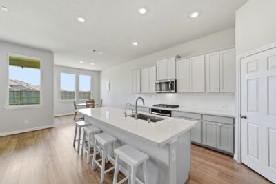 Gourmet island kitchen with quartz countertops and stainless steel appliances at 2952 Golden Dust Drive