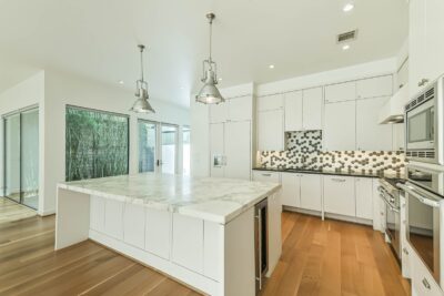 Designer kitchen showcasing custom finishes and generous workspace.