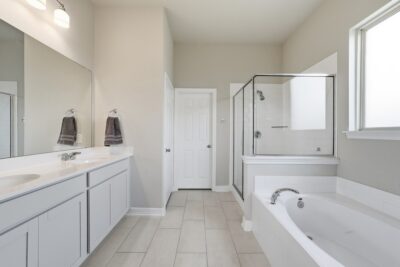 Primary bathroom with dual sinks, soaking tub and separate shower at 2952 Golden Dust Drive