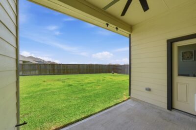 Covered backyard patio overlooking the oversized lot at 2952 Golden Dust Drive