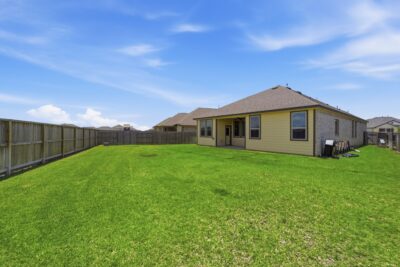 Oversized fenced backyard with no direct back neighbors at 2952 Golden Dust Drive