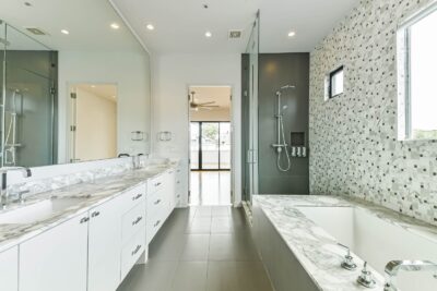 Spa-inspired primary bathroom with dual vanity and designer finishes.